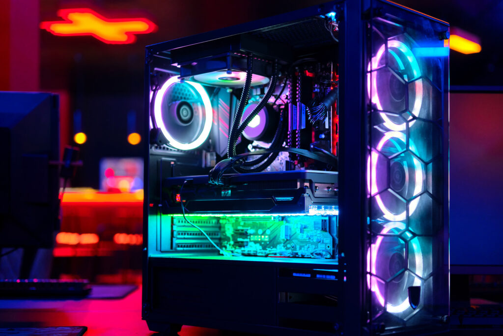 RGB-lit gaming PC with tempered glass case and internal components visible during a no-display troubleshooting issue